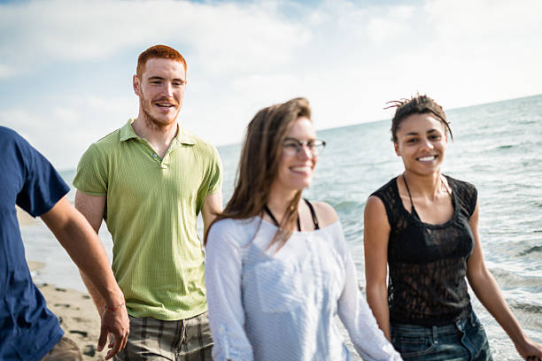 istock group of friends walking on the beach togetherness 587201506