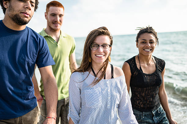 istock group of friends walking on the beach togetherness 587201620
