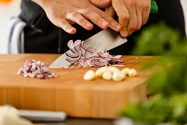 Chopping red onion on cutting board