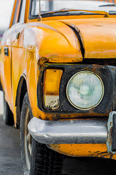 istock Vintage car yellow. Closeup. Broken. 587202140