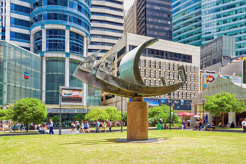 Singapore, Singapore - March 1, 2016: Ship sculpture near MRT subway entrance at One Raffles Place in Financial Center of Singapore. People in the street.