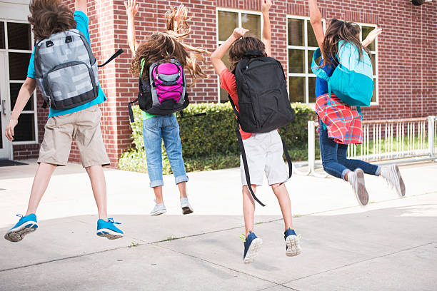 istock Elementary-age children jump for joy about going back to school. 587202176
