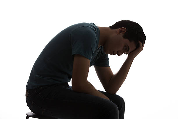 istock Young latin man sitting with hand on forehead. 587203104