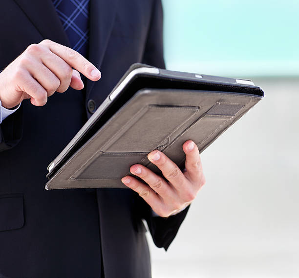 istock Close up of the businessmans hands with a tablet PC 587203946