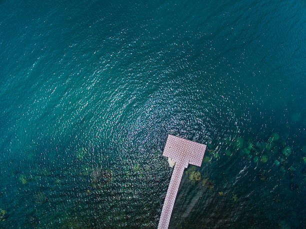 Pontoon bridge stretching into the distance the clouds in deep water