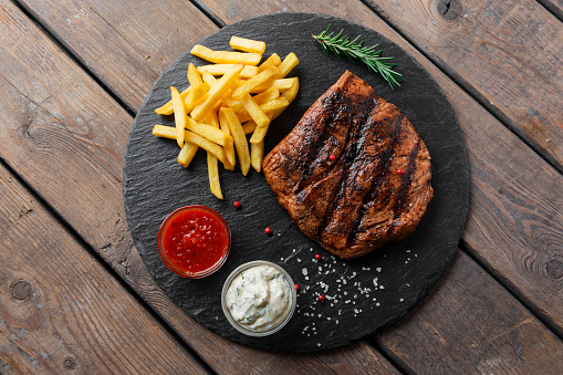 Beef steak with french fries and sauce