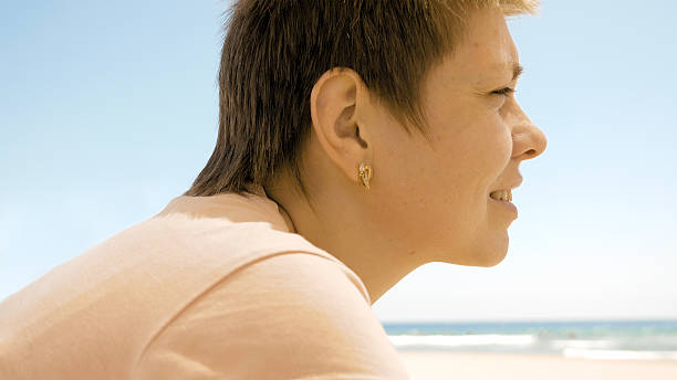 istock Female enjoying the scenery at the beach 587205086
