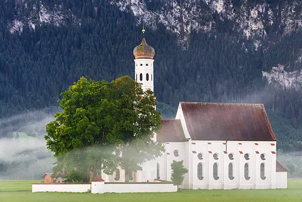 Beautiful St. Coloman Church in Schwangau (Bavaria, Germany) on Misty Summer Morning