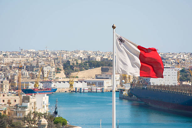 Maltese flag View of a Maltese flag waving. city of london flag stock pictures, royalty-free photos & images