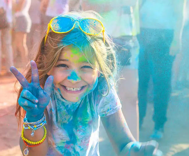 Photo of Portrait of happy litttle girl on holi color festival