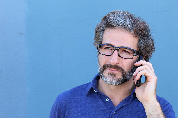 sonriente hombre de negocios maduro hablando por el teléfono celular - sales manager fotografías e imágenes de stock