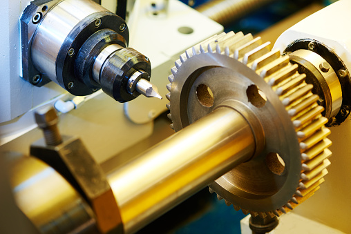 Close up of lathe machine processing in workshop.