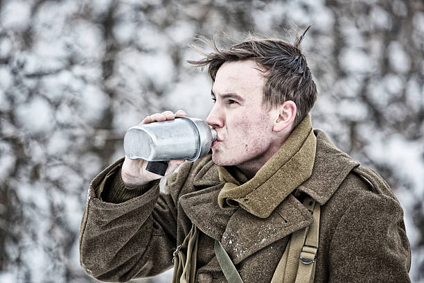 istock WWII GI Drinking From Canteen In Snowy Forest 587208196