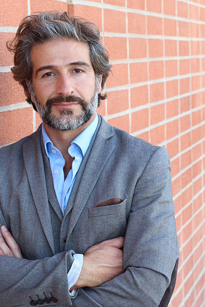 istock Handsome bearded man with his arms crossed 587209190