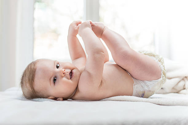 istock Cute baby child lying on white sheet 587209264