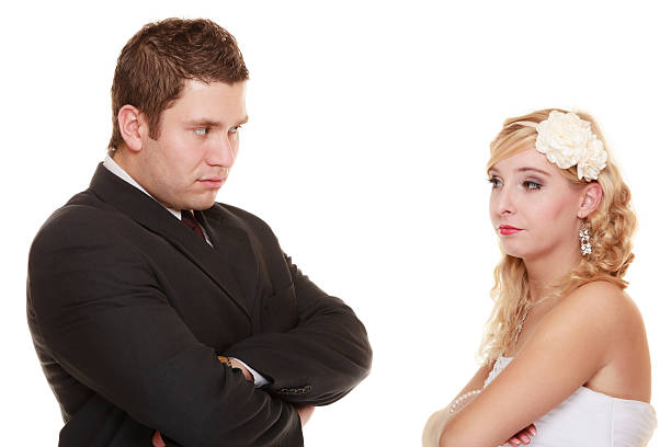 istock bride and groom looking at each other offended 587210490
