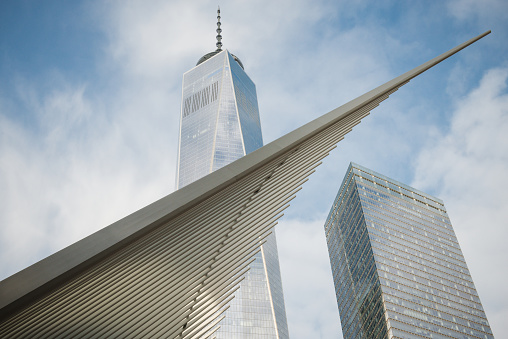 New York, USA - January 14, 2016: The Oculos, The World Trade Center Transportation Hub in Lower Manhattan part of PATH, with the The Freedom Tower in the background late in the day. The Transit Center was designed by Santiago Calatrava.