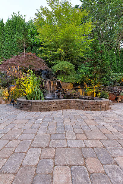 Paver Brick Patio with Waterfall Pond Backyard Garden Paver Brick Patio with Waterfall Pond and Landscaping pond photos stock pictures, royalty-free photos & images