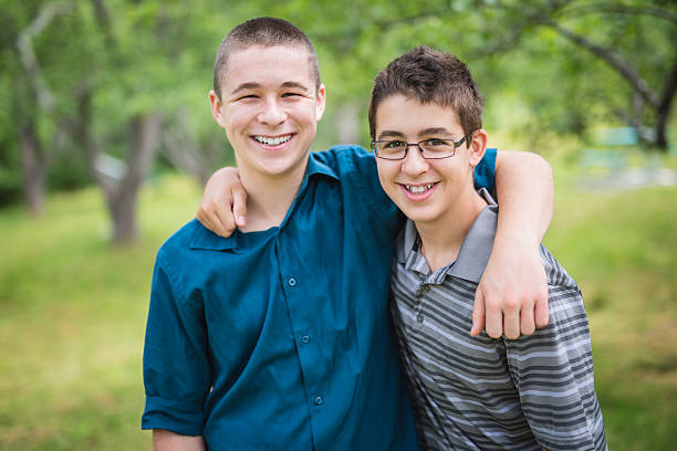 istock cute brothers outside in forest 587213446