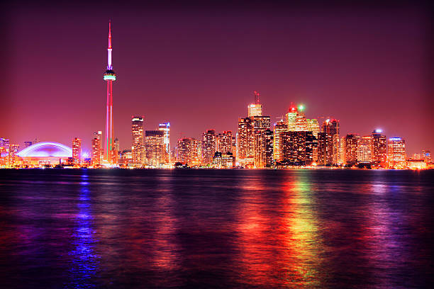 Illuminated Toronto City and the CN Tower at Night, with Water Reflection from Lake Ontario