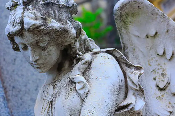 Photo of Young sad, beautiful fragile Madonna Angel, Recoleta cemetery, Buenos Aires