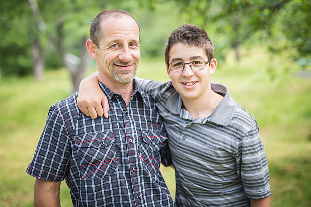 istock Father with son outside in a forest 587214500