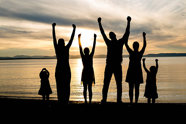 istock six family member at beach silhouette sunset 587215600
