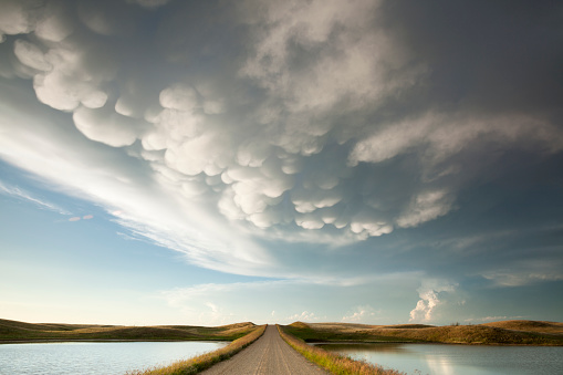 Mammatus storm clouds over a prarie dirt road, Saskatchewan, Canada