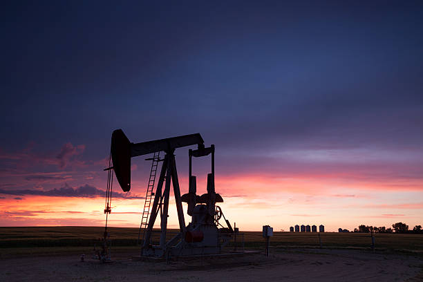 Prairie Oil Saskatchewan Sunset over Weyburn Saskatchewan, local oil. Image taken from a tripod. country geographic area photos stock pictures, royalty-free photos & images