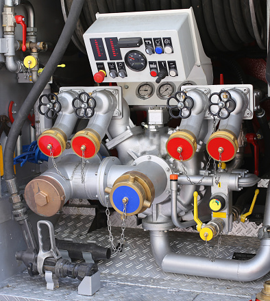 large automatic pump nozzles in fire truck with gauges and controls