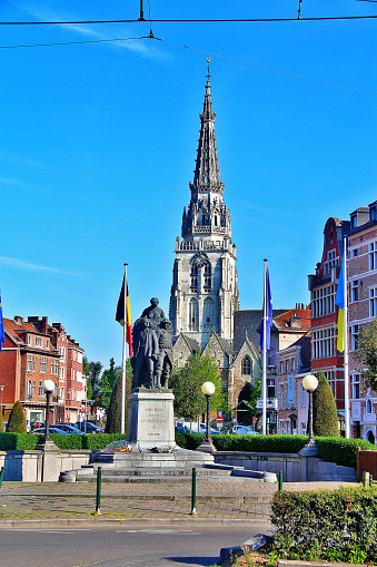 Brussels (Brussels), Belgium - May 08, 2016 - Place de la Vaillance and Collegiate Church of Saints Peter and Guidon of Anderlecht with Monument Aan onze helden (The Church and Monument erige to the Heroes of war, 1914-1918) in Anderlecht.