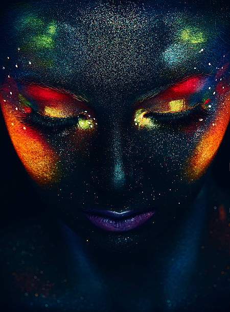 Glowing neon makeup with dramatic look. Glowing neon makeup with dramatic look in his eyes. Creative body art on the theme of space and stars. Amazing close-up portrait glow in the dark makeup. human eye nebula star space stock pictures, royalty-free photos & images