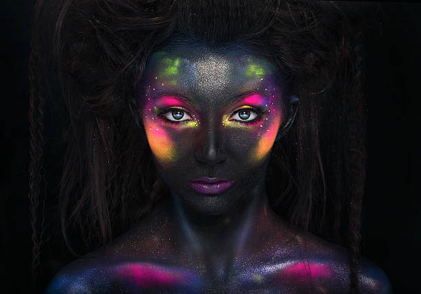 Glowing neon makeup with dramatic look. Glowing neon makeup with dramatic look in his eyes. Creative body art on the theme of space and stars. eye nebula stock pictures, royalty-free photos & images