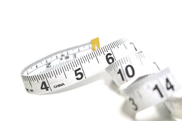 istock Close up of Measuring Tape on White Background 587223448
