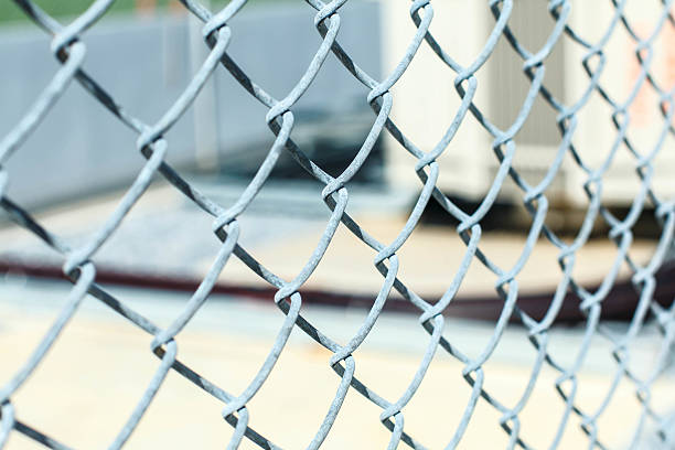 istock fence with metal grid in perspective 587225446