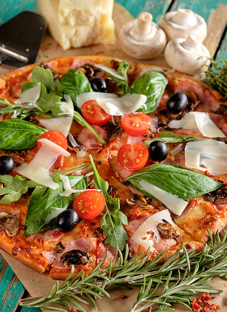 istock Homemade delicious pizza with bacon, tomatoes, olives and basil 587226174