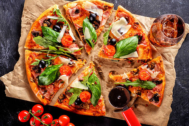 istock Homemade delicious pizza with bacon, tomatoes, olives and basil 587227242
