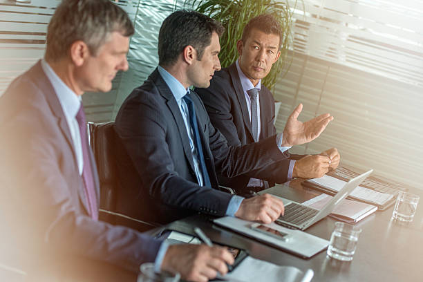 istock Three businessmen at a meeting 587227362