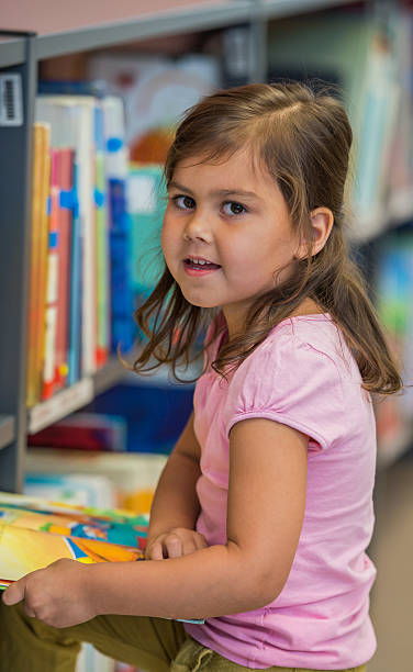 istock Cute Little Girl In Library 587229588