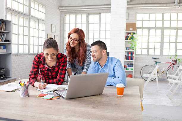 istock Team of young designers discussing new ideas at workplace 587230260
