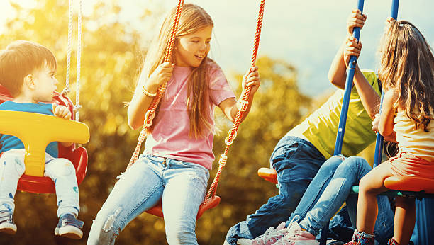 istock Children playing on a swingset. 587230682