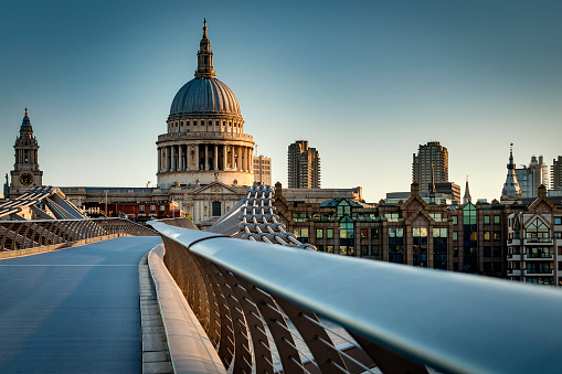 St Paul’s cathedral dome and the rail from the Millennium bridge, early in the morning twilight in London, England, UK. Saint Paul Cathedral is an Anglican church
