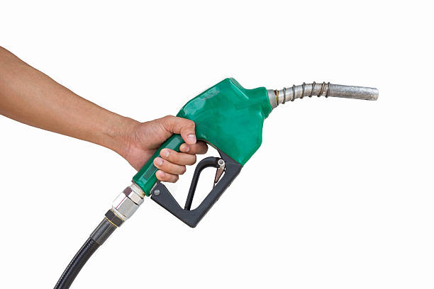 istock Man holding petrol pump isolated on white background. 587505428