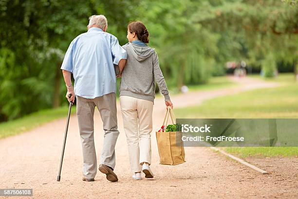 Caregiver Woman Helping Senior Man With Shopping Stock Photo - Download Image Now - Senior Adult, Assistance, Home Caregiver