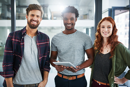 Portrait of three young creatives working together in a modern office