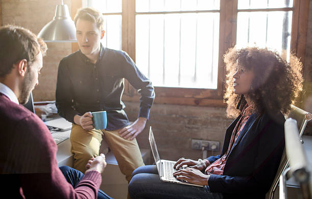 istock Creative business people having a casual discussion in the office 587508586