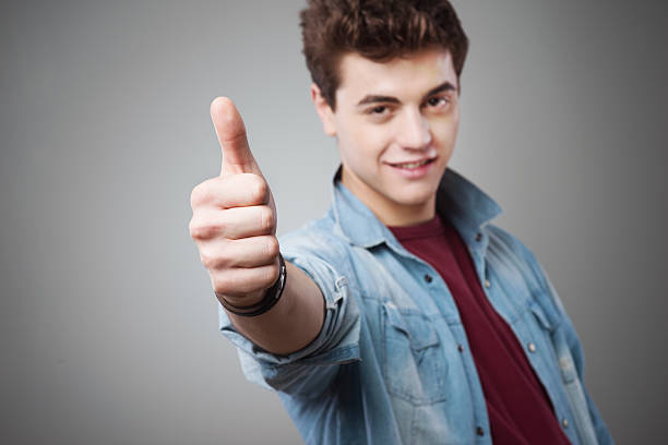 istock Smiling teenager thumbs up 587509250