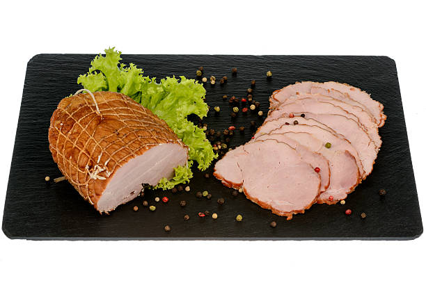 istock Fresh smoked ham on black board isolated. 587509516