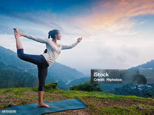 Woman Doing Yoga Asana Natarajasana Outdoors At Waterfall Stock Photo - Download Image Now