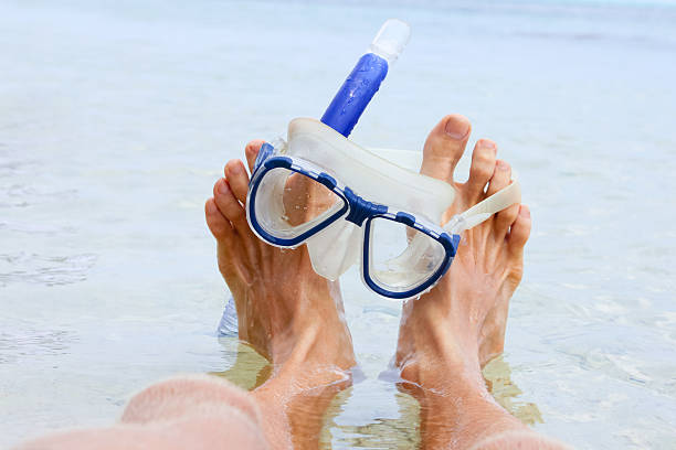 istock Man resting on the beach with snorkel mask 587510960